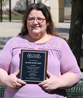 Anne-Marie Baccus holding award